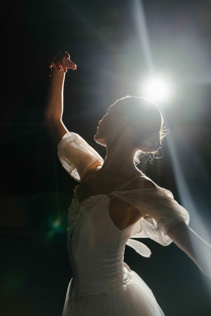 Girl dancing under a spotlight