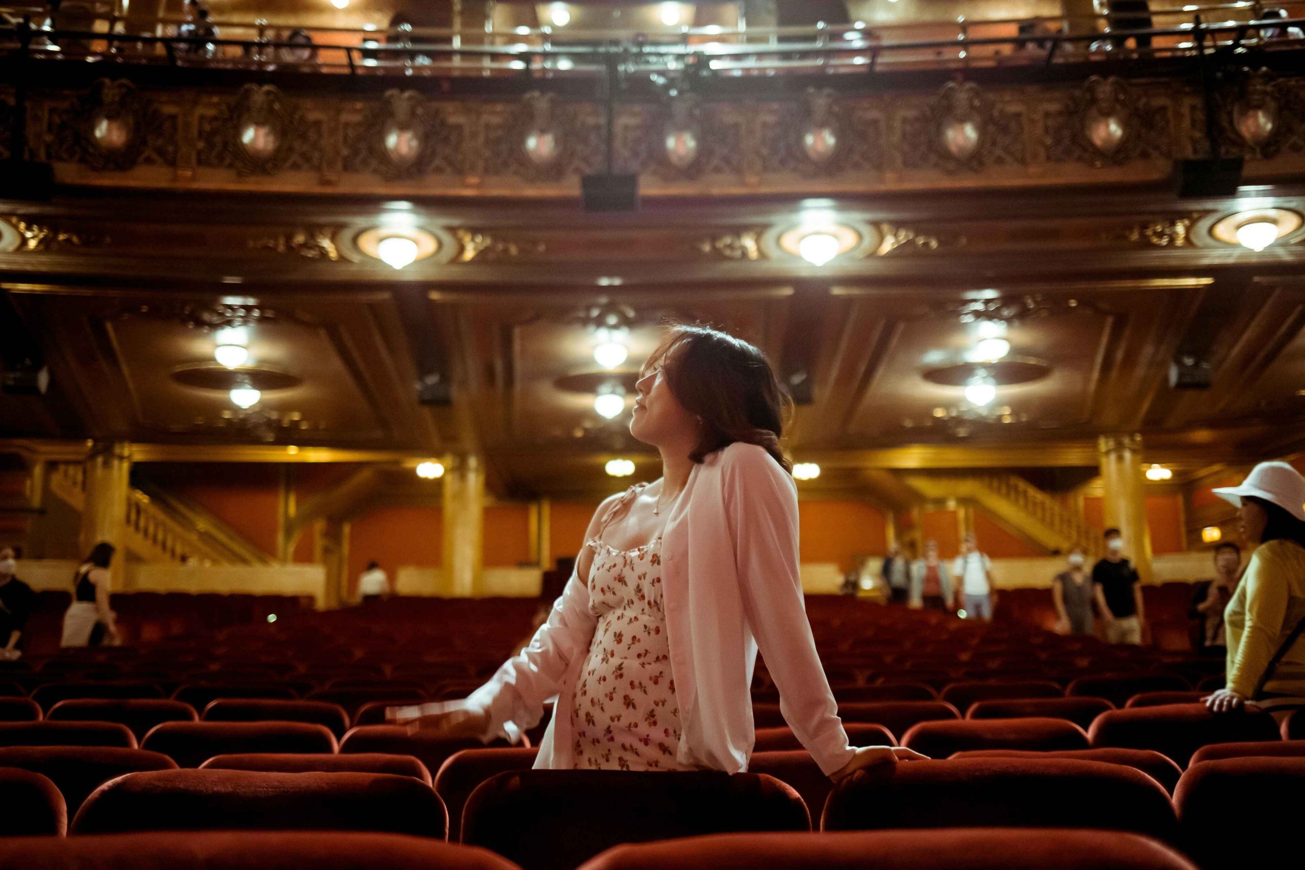 Person looking around a theater in the seats