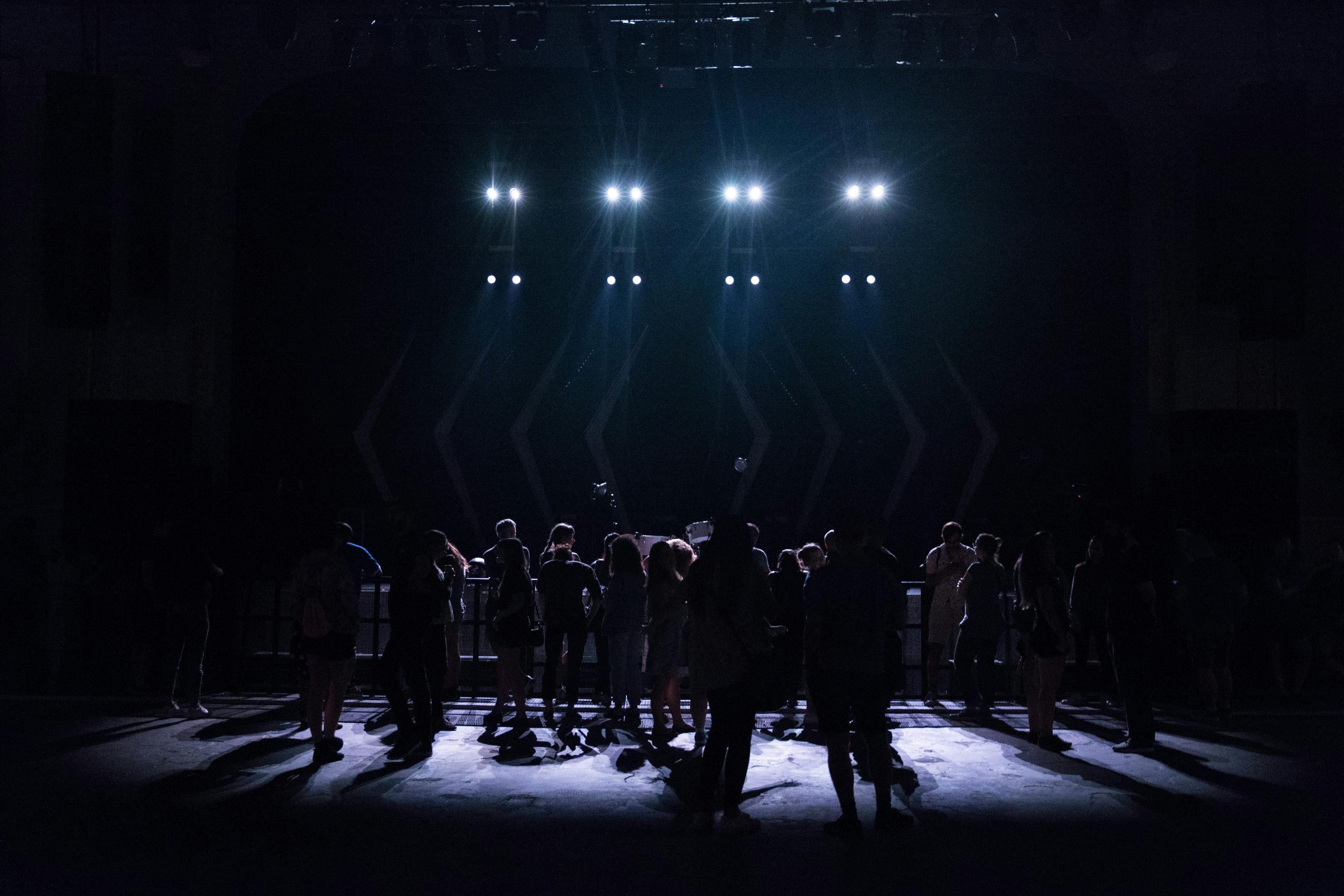 People on a dark stage with spotlights on them